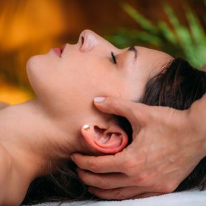 CST therapist Massaging Woman’s Head. Craniosacral Therapy Massage.